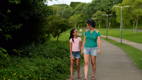 Woman-and-girl-walking-at-the-park